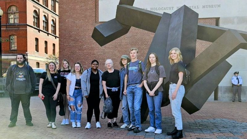 students standing in front of sculpture outside museum