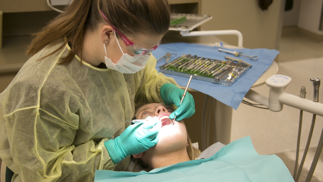 Dental Assistant student with patient