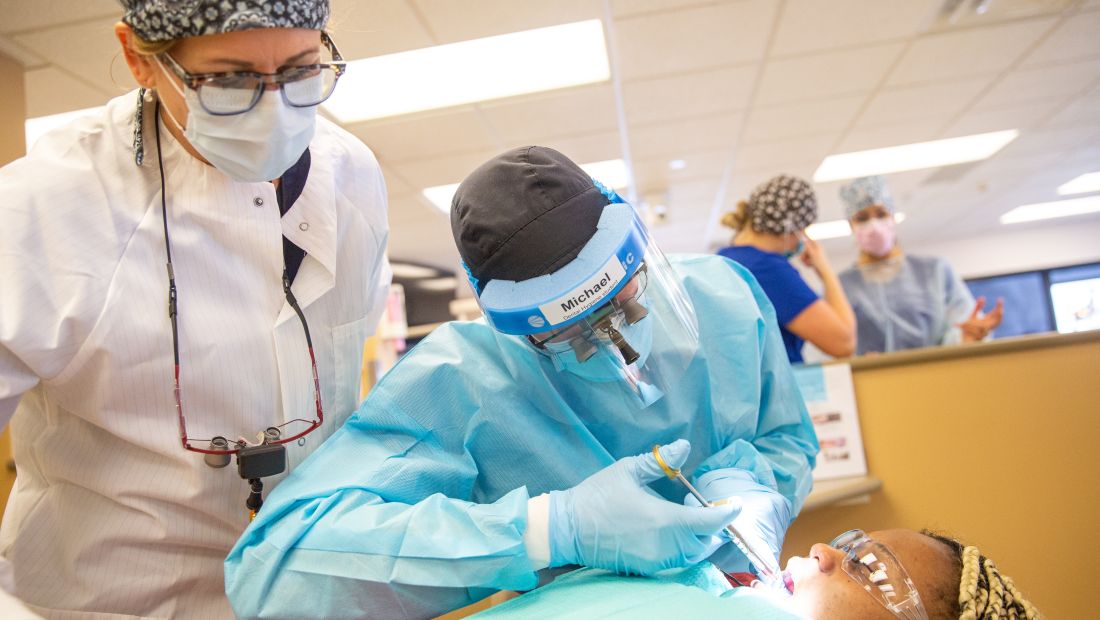 Dental Hygienist student with patient