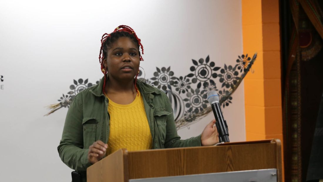 black student speaking at podium