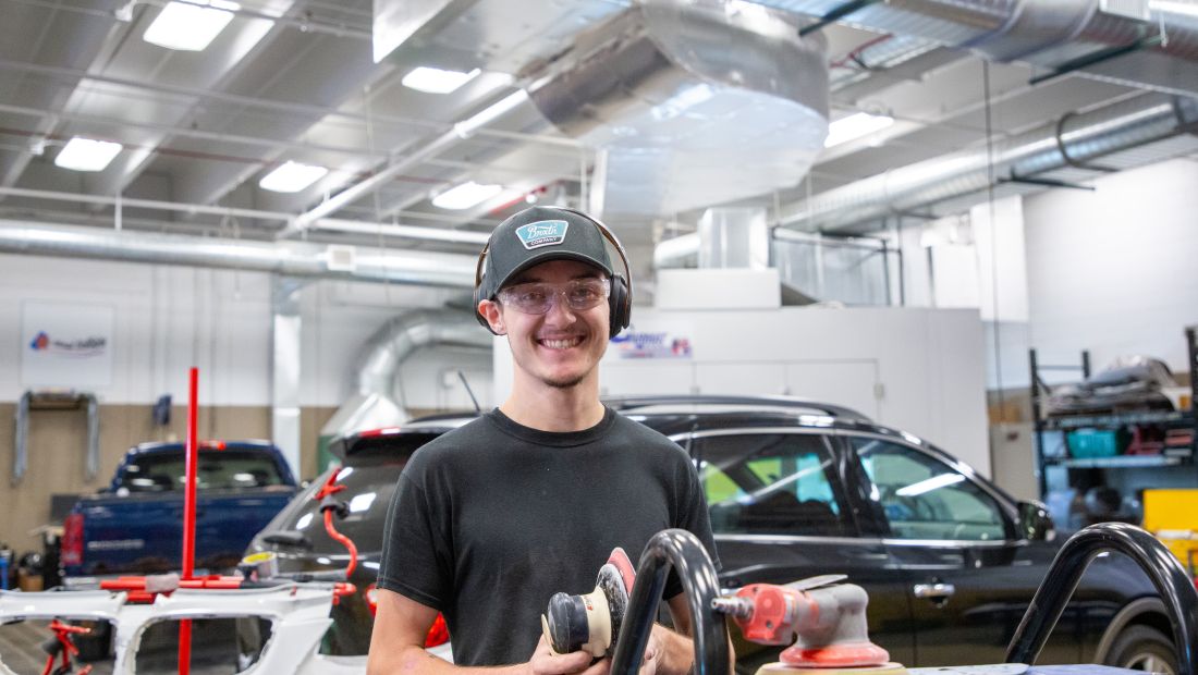 auto body student with sander