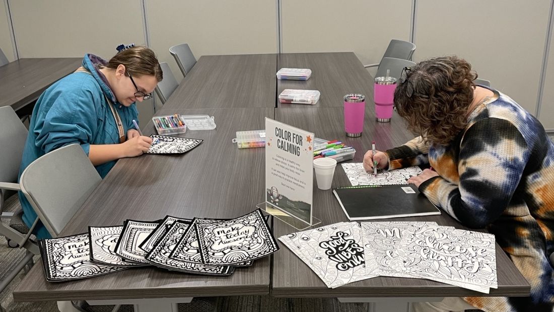 Two people coloring at a table