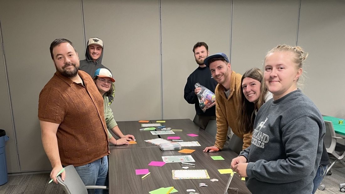 a group of students at the affirmation table, smiling