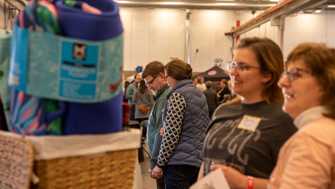 People looking at the silent auction