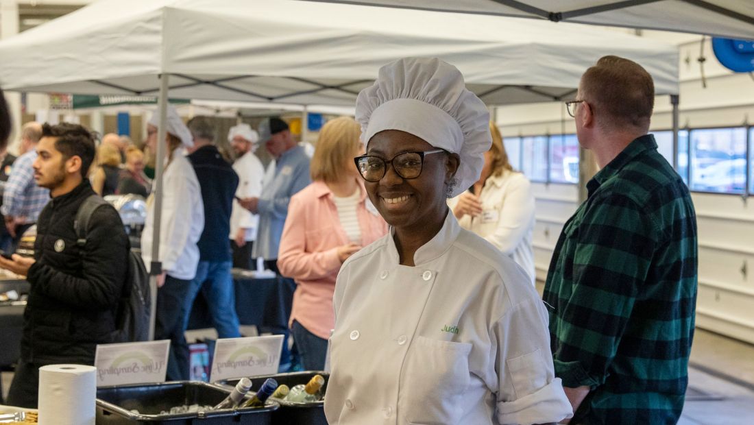 culinary student smiling under tent