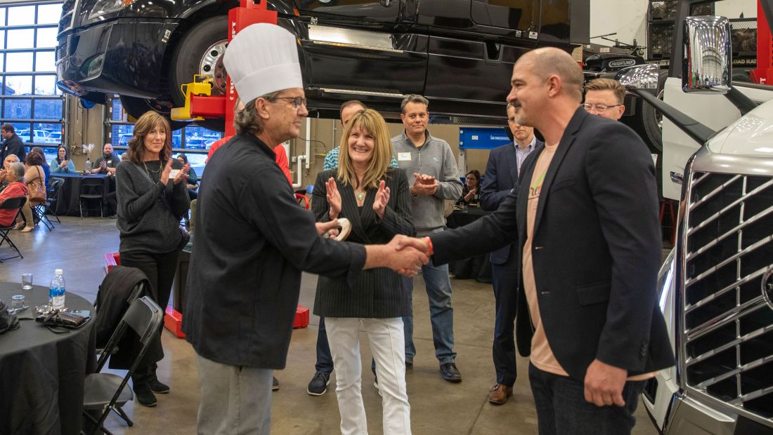 Chef and Daniel shaking hands, Lori clapping