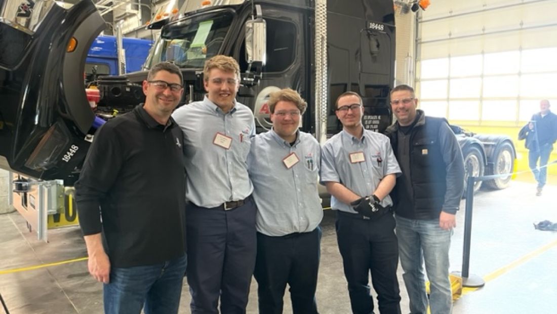 MHT students in front of a semi on a lift