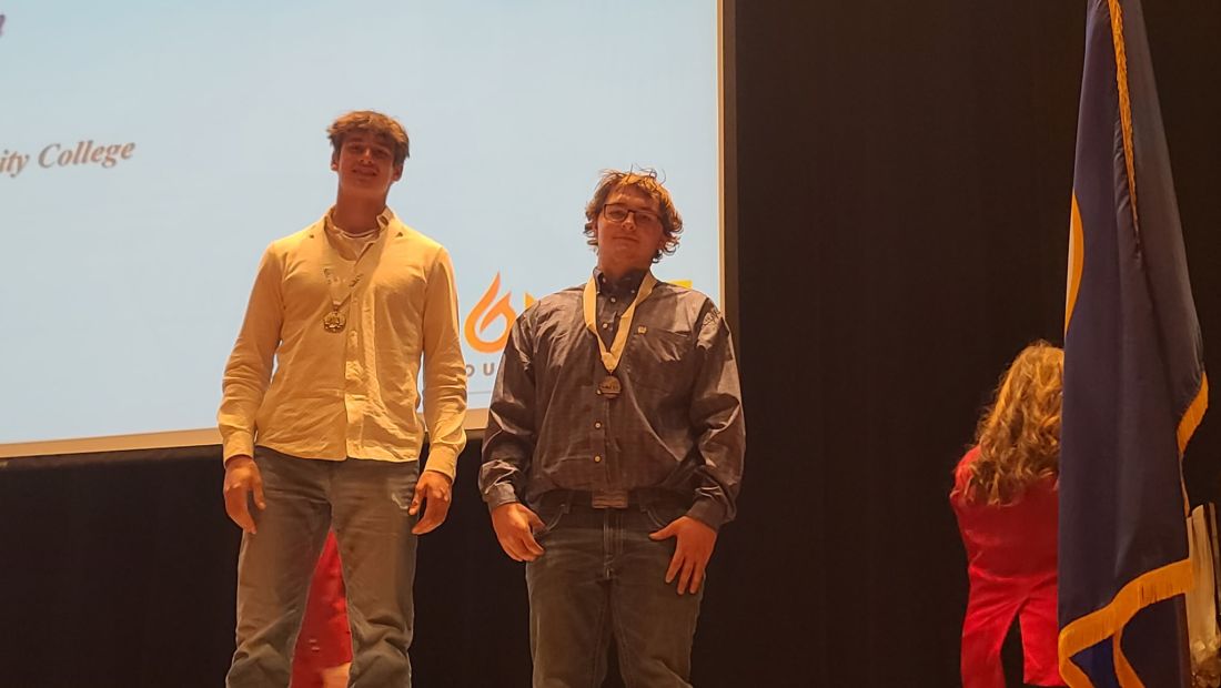 two students with medals around their necks