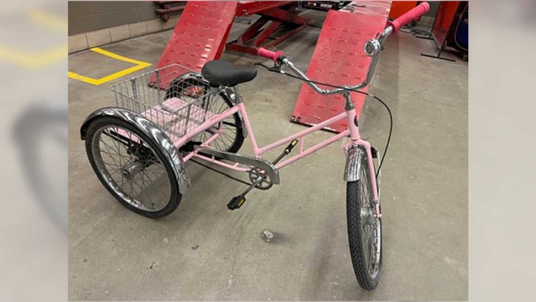 a pink tricycle with a basket
