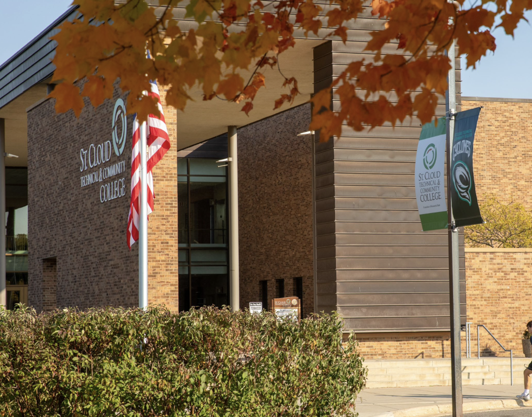 Front of SCTCC in fall with students stepping on sidewalk