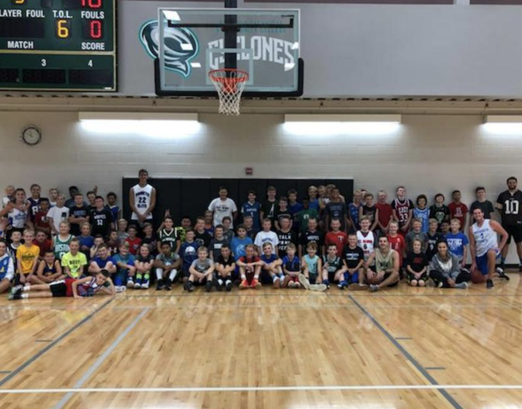 Basketball campers lined up for a photo under the Cyclones logo