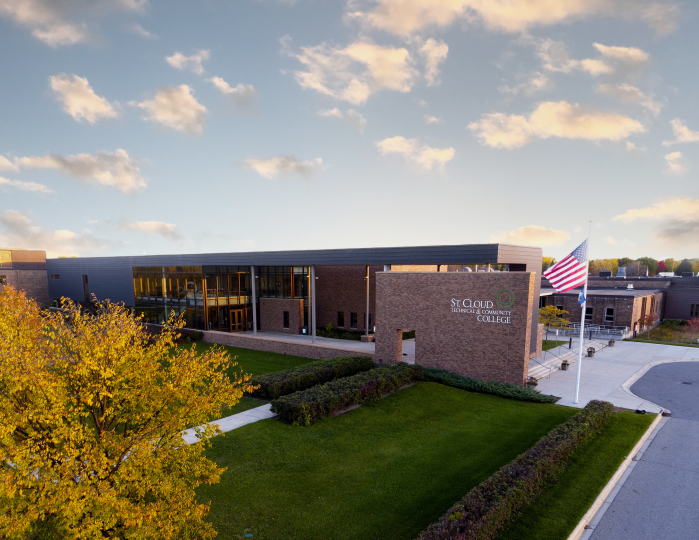 overhead view of SCTCC main entrance. Tree with yellow leaves in forground, sky with sunset clouds