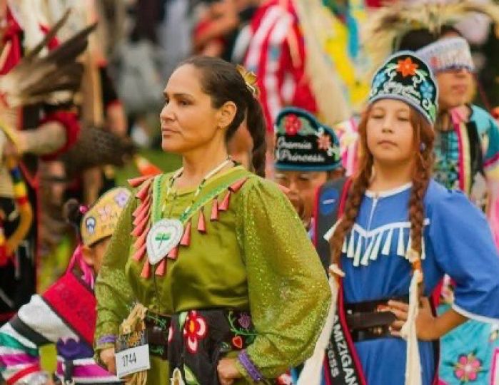 Native American Woman in traditional dress dancing