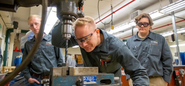 Energy and Electronics students using drill