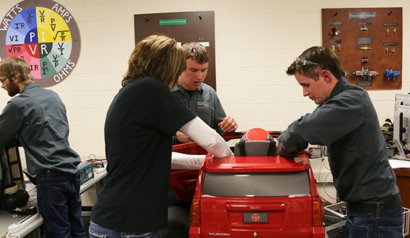 Energy and Electronics students working on red car