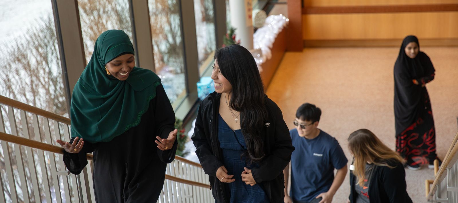 Students walking up a staircase in main entrance