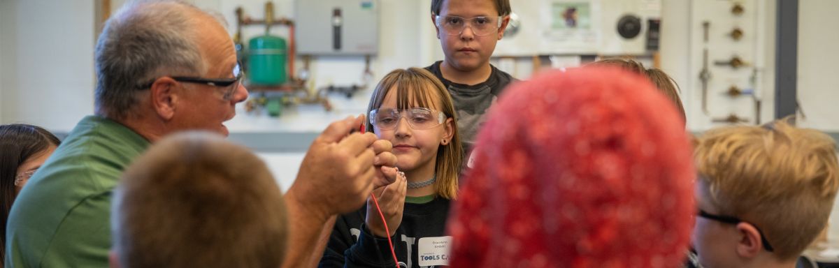 campers gathered in a group, learning about wiring
