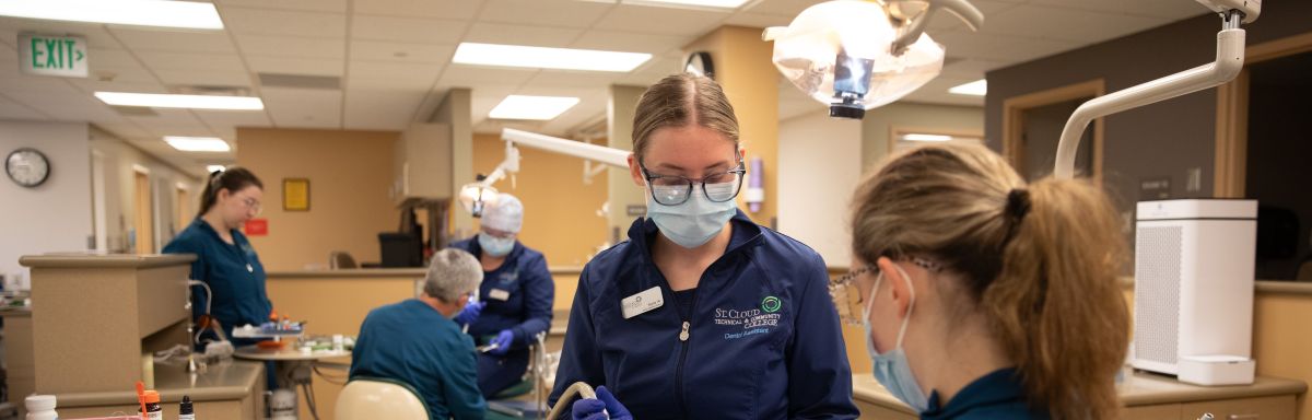 a group of dental assisting students in lab, practicing techniques 