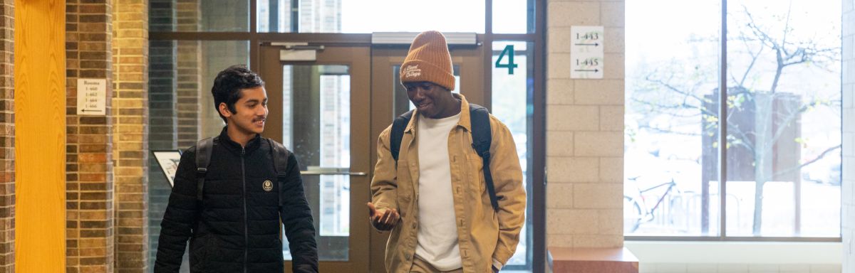 students walking in a hallway, chatting