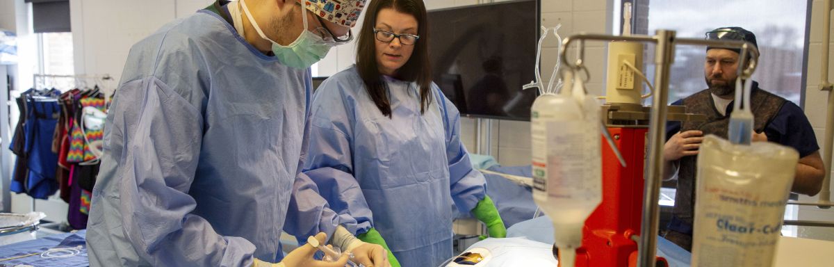 CVT instructor guides student in full gear in practice procedure