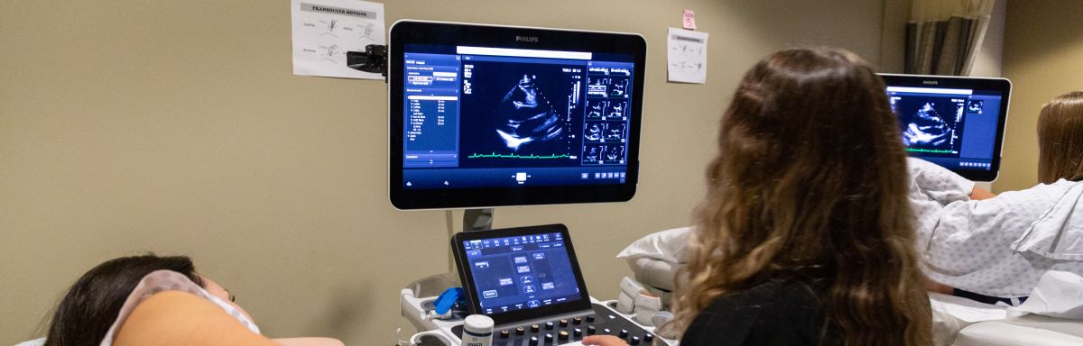 two echo students scanning, with scans on screens