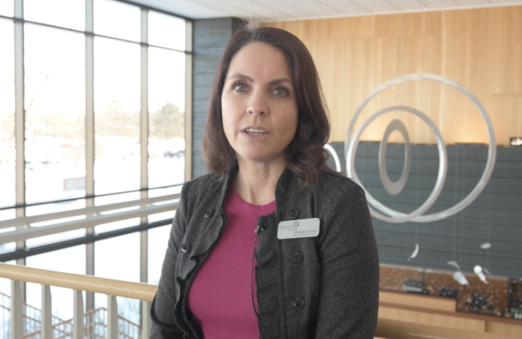 Michelle stands at top of stairs