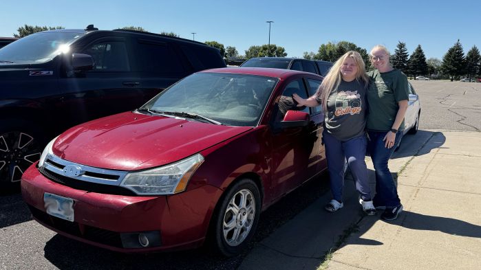 Heather and Leanne posing in front of the red ford focus