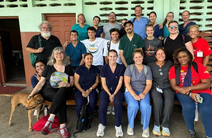 The volunteer group in three rows, smiling at the camera