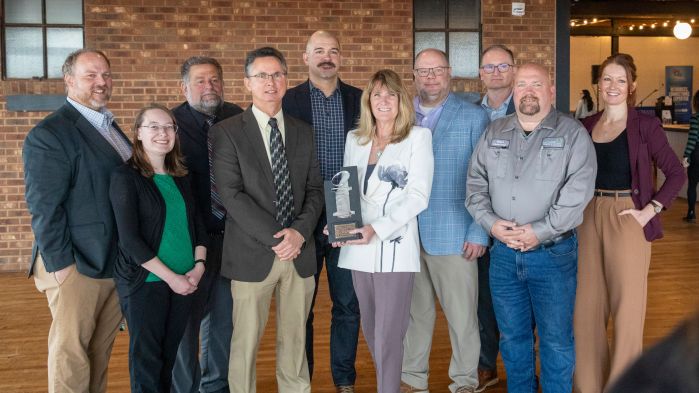 10 SCTCC folks lined up with the Innovation award ready to have photo taken before the presentation