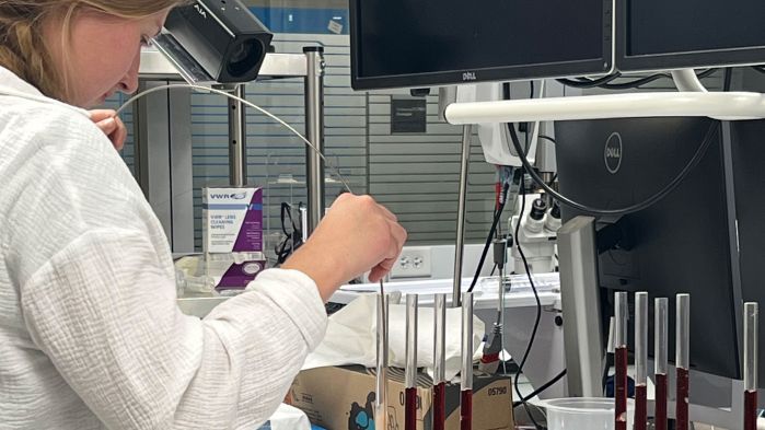 Woman working with instruments in a lab