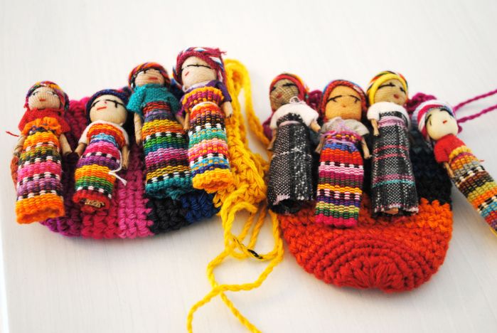 eight worry dolls lined up