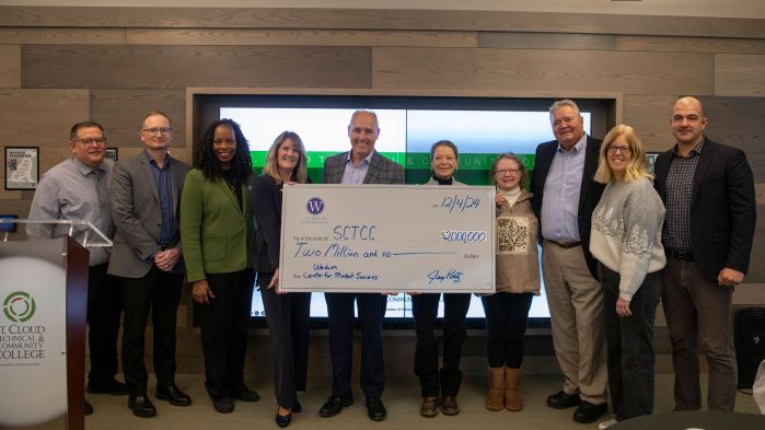 group of SCTCC and Wedum folks holding big check and smiling