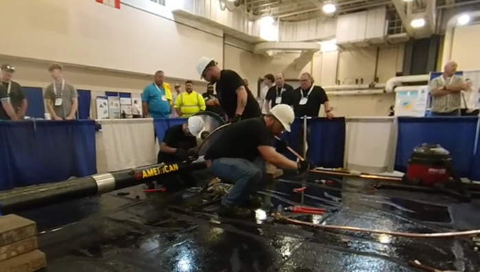 Three SCTCC students at pipe-tapping