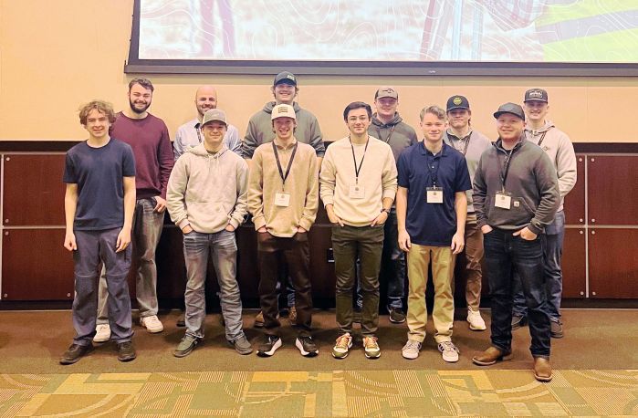 Group of land survey students in two rows smiling at camera