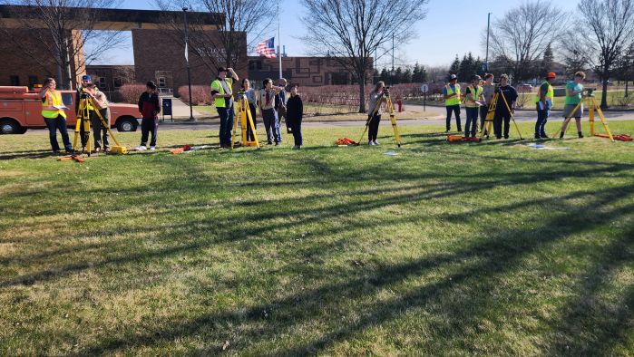 land survey students and Scouts using equipment in front of SCTCC