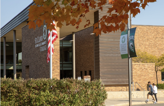 Front of SCTCC in fall with students stepping on sidewalk