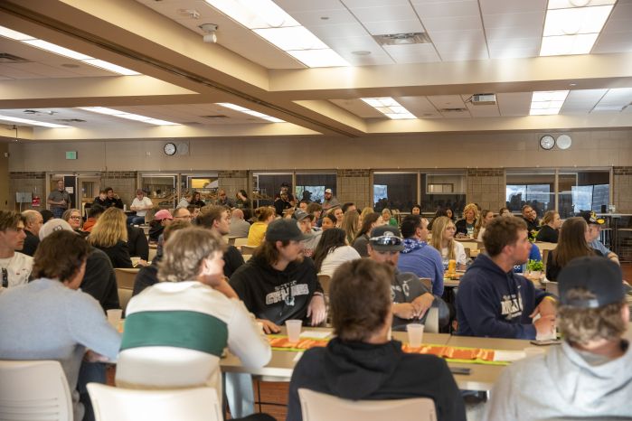 Crowd sitting at tables in the Commons for the event
