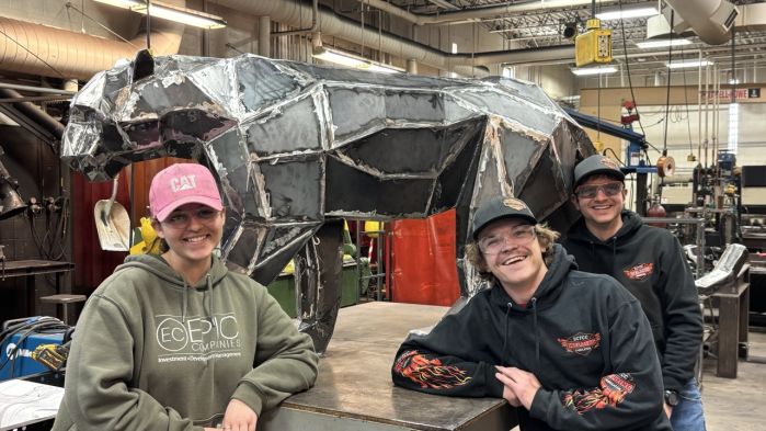 Jasslyn, Logan, and Josh posing in front of the panther before it heads to All Pro 