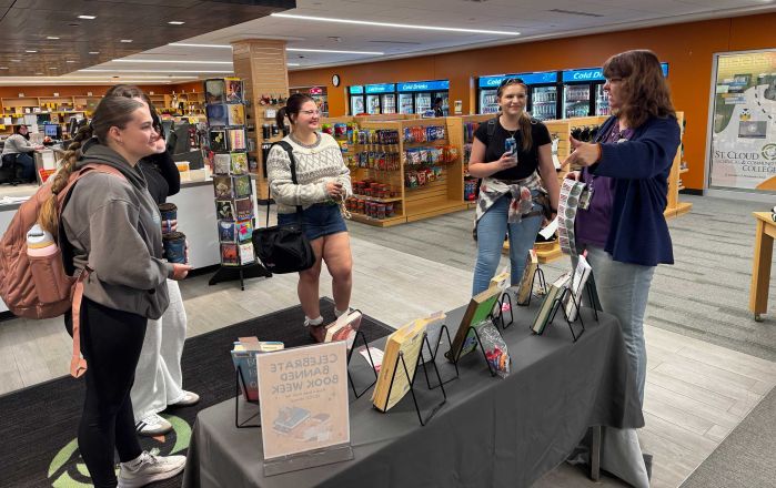 Mary talking to four students about banned books