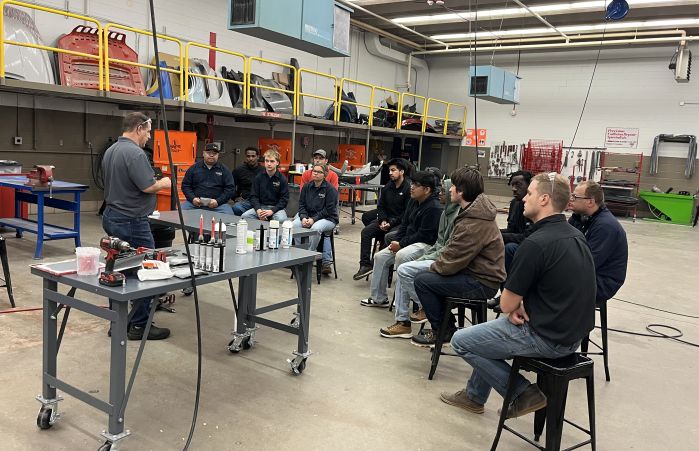 students listening to presenter in a large lab