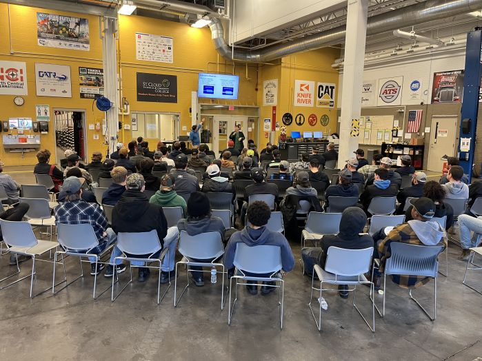 Group of students in chairs watching a presenter