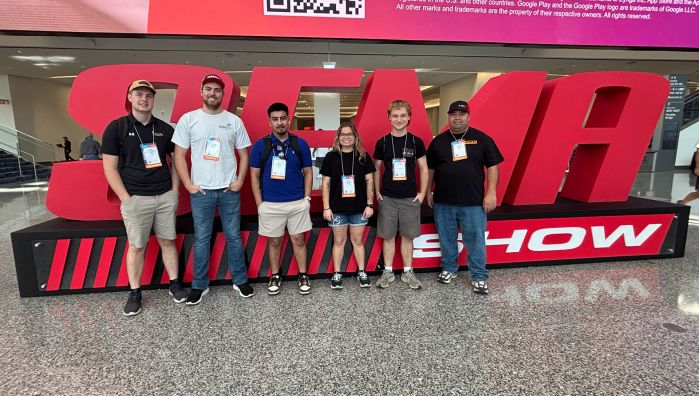 Five SCTCC folks in front of a giant SEMA statue