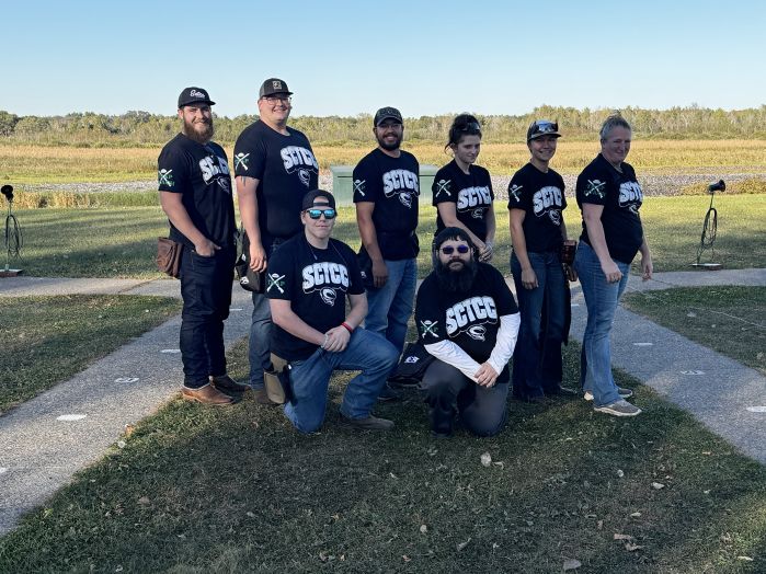 Trap team posing for the camera in two rows