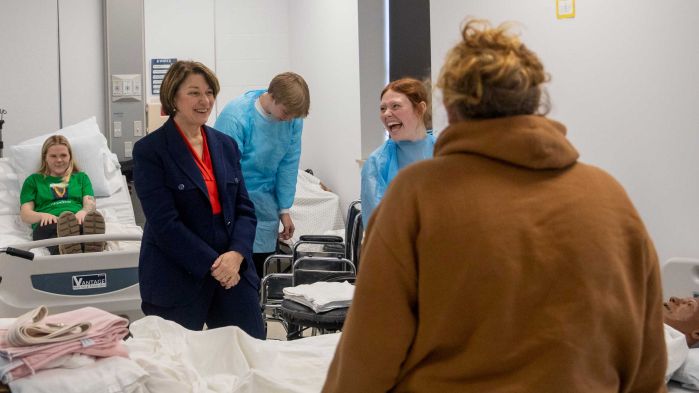 Amy Klobuchar chats with students and instructors in the nursing lab