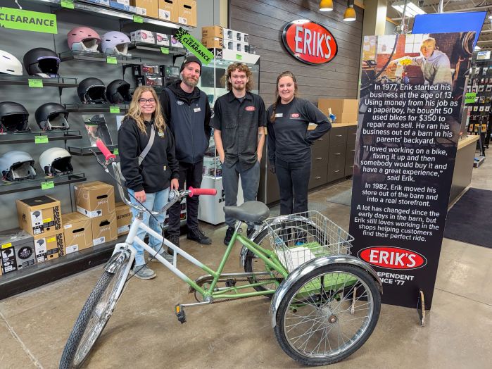 student and Erik's bike shop employees pose with freshly painted bike