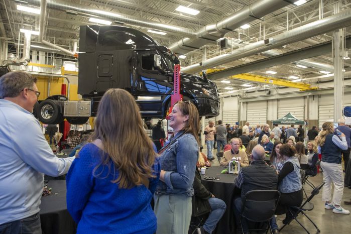 Large group of folks at brewlash with a semi up on a lift