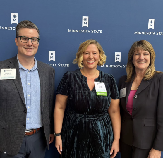Ken, Kami, and Lori in front of a MinnSTate backdrop