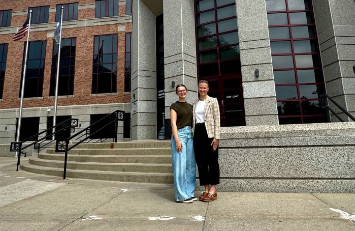 Ava and Emma on the steps of the Stearns County building