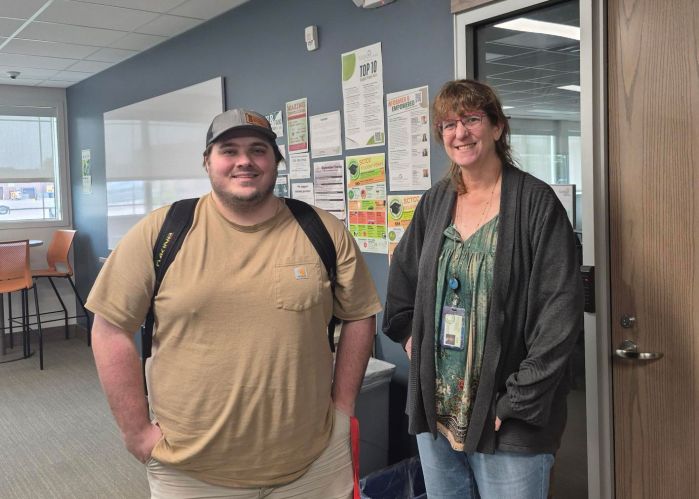 John and Mary standing side by side in the library