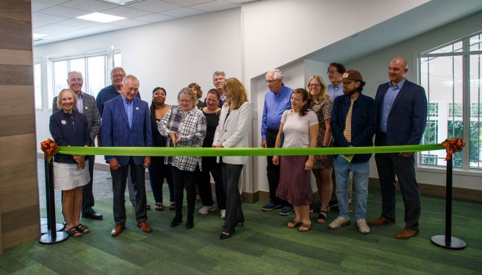 group of folks cutting the ribbon at a grand opening